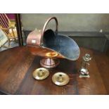 Copper coal scuttle and three candlesticks