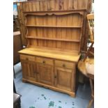 Pine dresser with raised back ,three drawers and cupboards below.