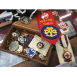 Box of Girl Guides and Red Cross badges, including silver and enamel