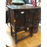 Old charm style side cupboard with carved decoration and turned legs joined by stretchers