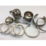 Silver mustard pot, silver salt, white metal salt spoon, silver torque bracelet, two other metal ban