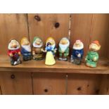 Miniature character figures including Snow White and the Seven Dwarfs and others
