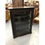 Late Victorian ebonised display cabinet with three shelves enclosed by glazed door.