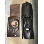 Large African carved wooden mask, and two carved wooden panels