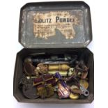 Old tin containing penknives, medals, painted lead man and monkey etc