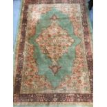 Old Persian rug with central medallion on green ground