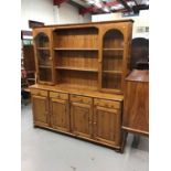 Pine dresser with raised back and three drawers and doors below