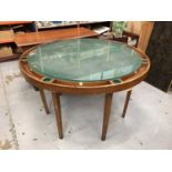 Games table of circular form with green baize top and glass cover