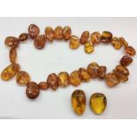 Amber bead necklace and two other pieces of amber
