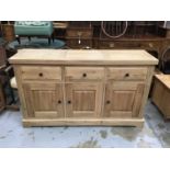 Light oak sideboard with three drawers and cupboards below