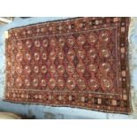 Old Bokhara rug with repeating medallion design on reg ground