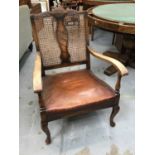 1920s Bergere elbow chair with caned back and brown leather seat, together with a 1920s mahogany and