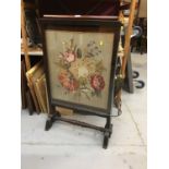 Victorian firescreen with floral embroidered panel in mahogany frame on splayed legs