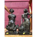 Two bronzed resin sculptures of Ladies on stone plinths