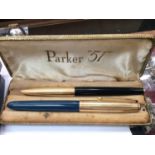 Set of two Parker pens and set of three Pierre Farber pens, both cased