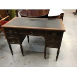 Edwardian oak kneehole desk with lined top,five drawers with ornate brass handles on fluted taper le