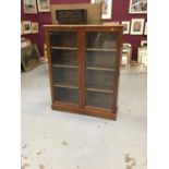 Mahogany book case enclosed by a pair of glazed doors