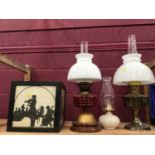 Three oil lamps and box shade with musician silhouettes