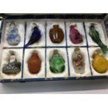 Collection of ten Chinese snuff bottles in silk covered box