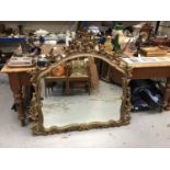 Ornate gilt framed over mantel mirror