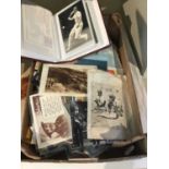 Box of postcards and an album of postcards