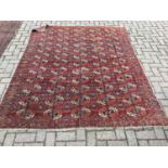 Eastern rug with geometric decoration on red ground, 230 x 188cm together with another similar measu