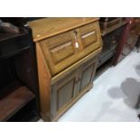 Golden oak bureau with fall flap and two carved panelled doors below, 85cm in width, 101cm in height
