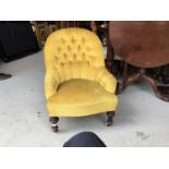 Victorian nursing chair with buttoned back golden velvet upholstery on turned legs with ceramic cast