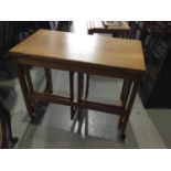 McIntosh teak metamorphic nest of three occasional tables together with a nest of three tile topped