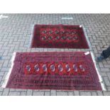 Two Eastern Rugs with geometric decoration on red ground, 155 x 104cm and 178 x 91cm