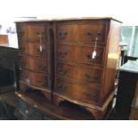 Pair of reproduction Georgian style walnut serpentine fronted bedside chests with four draws, on bra