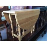 Contemporary pine drop leaf kitchen table on turned legs joined by stretchers, 92cm x 73cm x 47cm (f