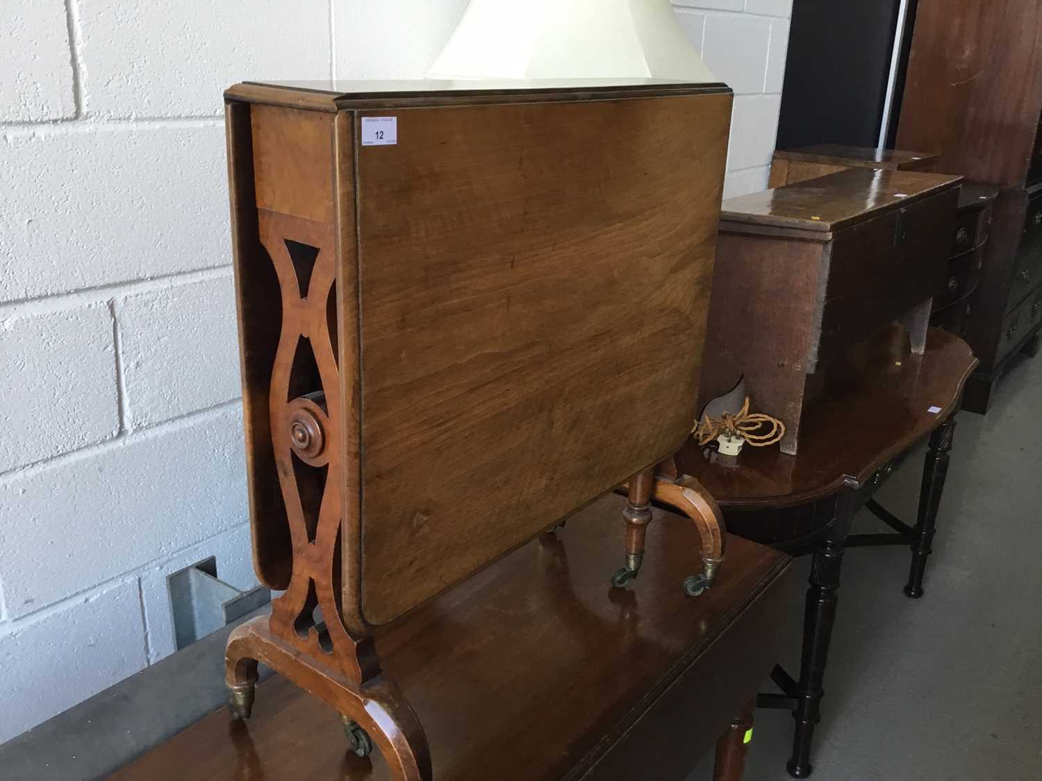 Victorian walnut Sutherland table with pierced decoration, on brass castors, 69cm length, 74cm heigh