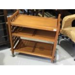 Unusual teak tea trolley with gothic style pierced sides, and removable trays, on castors, 75 x 76 x