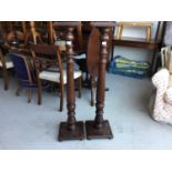 Pair of mahogany torcheres with turned columns, square tops and bases, on bun feet, base 28cm in dia