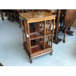 Edwardian Mahogany revolving book case with cross banded decoration on cabriole legs, 51cm in diamet