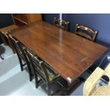 Oak refectory table with pierced ends joined by stretcher together with four ladder back dining chai