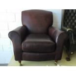Good quality contemporary brown leather arm chair by Marks & Spencer, on turned feet with brass cast