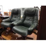 Pair of Contemporary green leather easy chairs on wooden bases, together with matching foot stools,