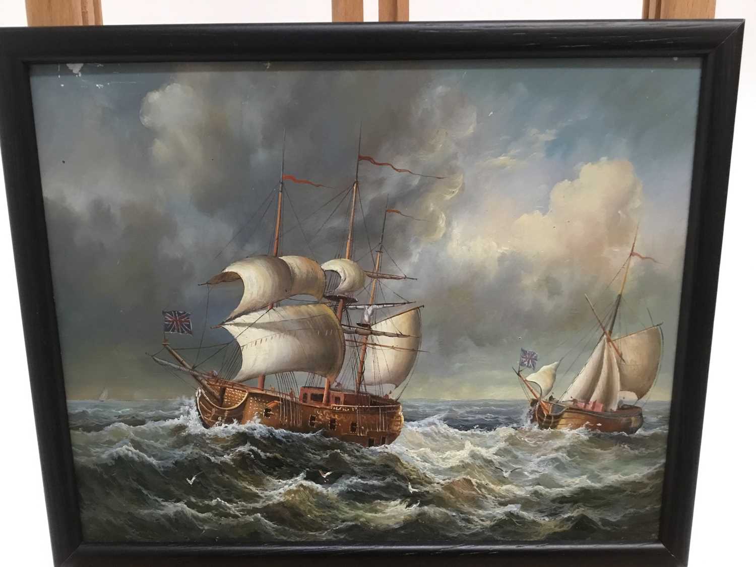 English School, 20th century, oil on panel, A man o' war and another vessel in choppy seas, in gilt