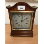 Modern Comitti of London mantel clock in mahogany case with arched top, on four brass feet, 23cm hig