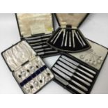 Two set of six silver coffee spoons, two set of six silver handled tea knives in fitted case and a n