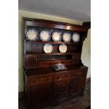 Early 18th century oak high dresser, the plate rack with an arrangement of drawers and cupboards, wi
