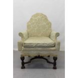 19th century wing arm chair with arched shaped back, on shaped stretcher and carved legs