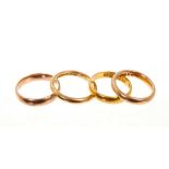 22ct wedding ring and three 9ct gold wedding rings
