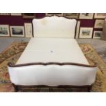 Late 19th century French mahogany framed double bedstead with shaped and padded head and foot board