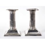 Pair of Edwardian silver dwarf Corinthian column candlesticks