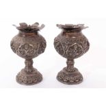Pair late 19th/early 20th century Indian white metal pedestal vases, with embossed decoration of Hin