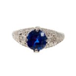 A fine sapphire single stone ring with a natural cushion cut blue sapphire weighing 2.66ct in four c