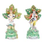 Charming pair of Staffordshire pearlware figures, circa 1820, showing a boy and girl with a dog and